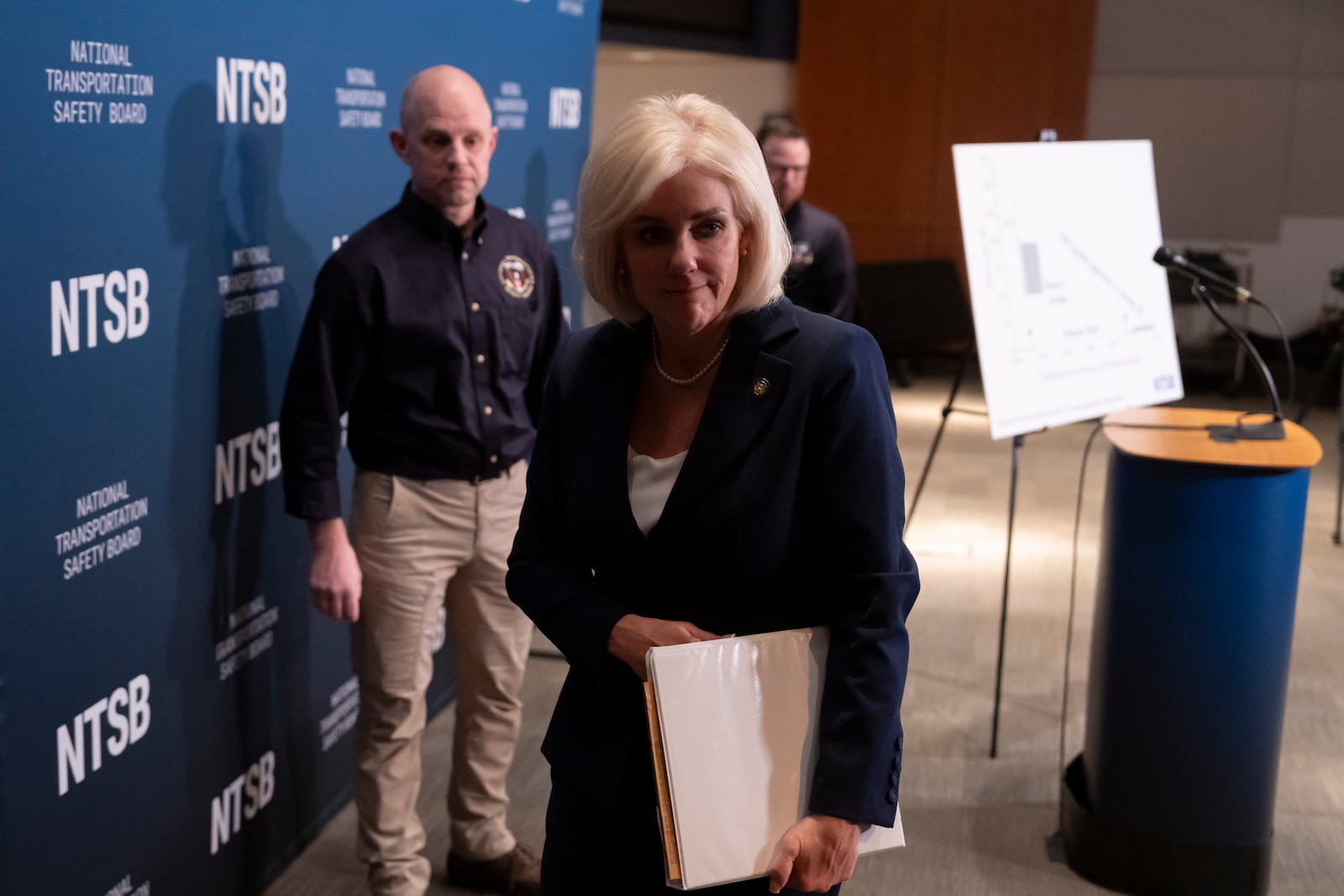 National Transportation Safety Board (NTSB) Chairwoman Jennifer Homendy, accompanied by investigator in charge Brice Banning, left, leaves after speaking about the recent mid-air collision of an American Airlines flight and a Black Hawk helicopter near Ronald Reagan Washington National Airport, at a news conference in Washington, Tuesday, March 11, 2025. (AP Photo/Ben Curtis)