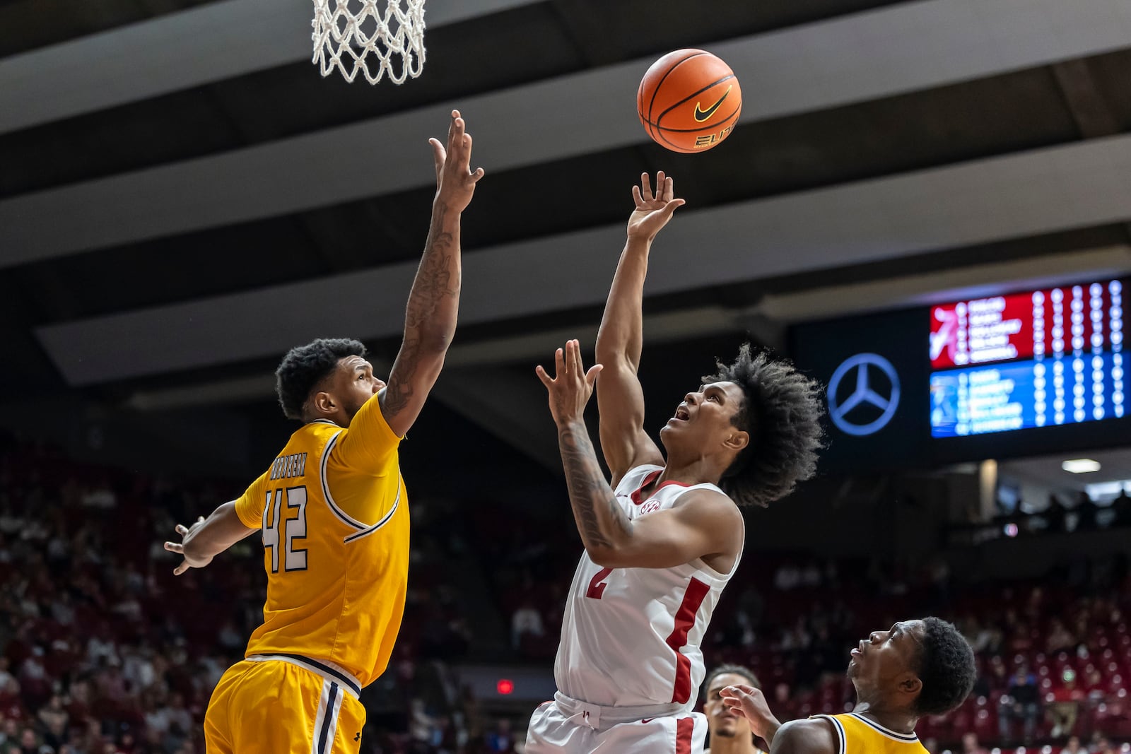 Alabama guard Aden Holloway (2) shoots over Kent State center Cli'Ron Hornbeak (42) during the first half of an NCAA college basketball game, Sunday, Dec. 22, 2024, in Tuscaloosa, Ala. (AP Photo/Vasha Hunt)