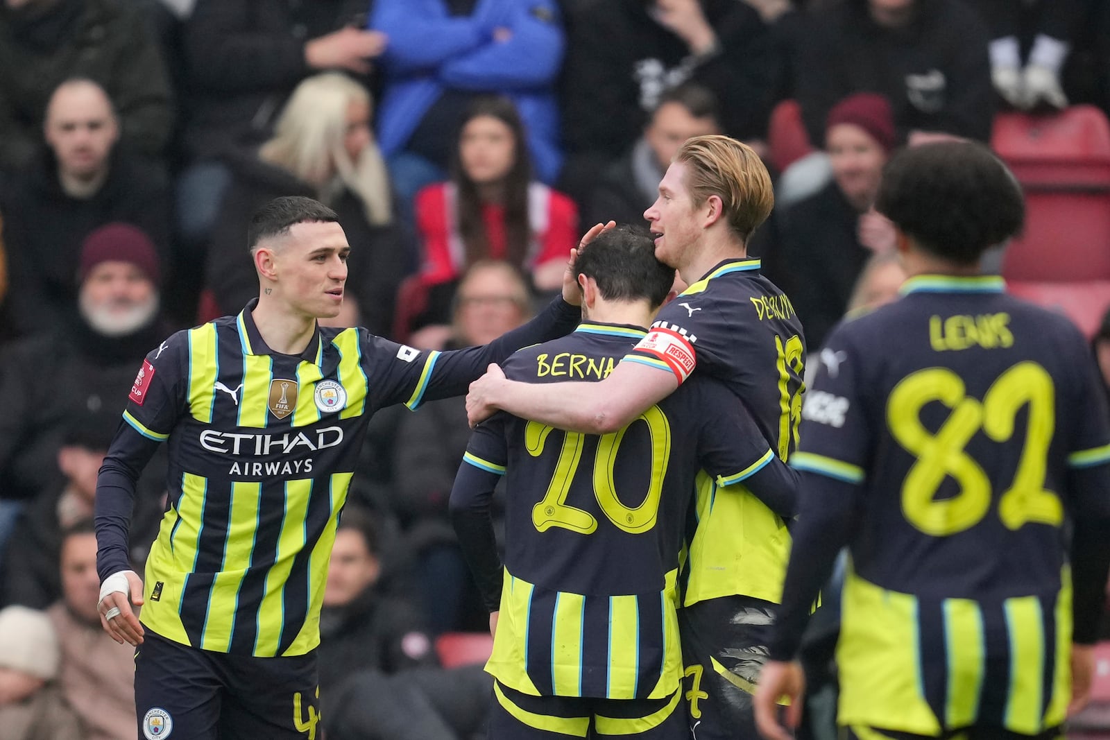 Manchester City players celebrate after Manchester City's Kevin De Bruyne, second right, scored his side's second goal during the English FA Cup fourth round soccer match between Leyton Orient and Manchester City at the Gaughan Group Stadium in London, England, Saturday, Feb. 8, 2025. (AP Photo/Kin Cheung)