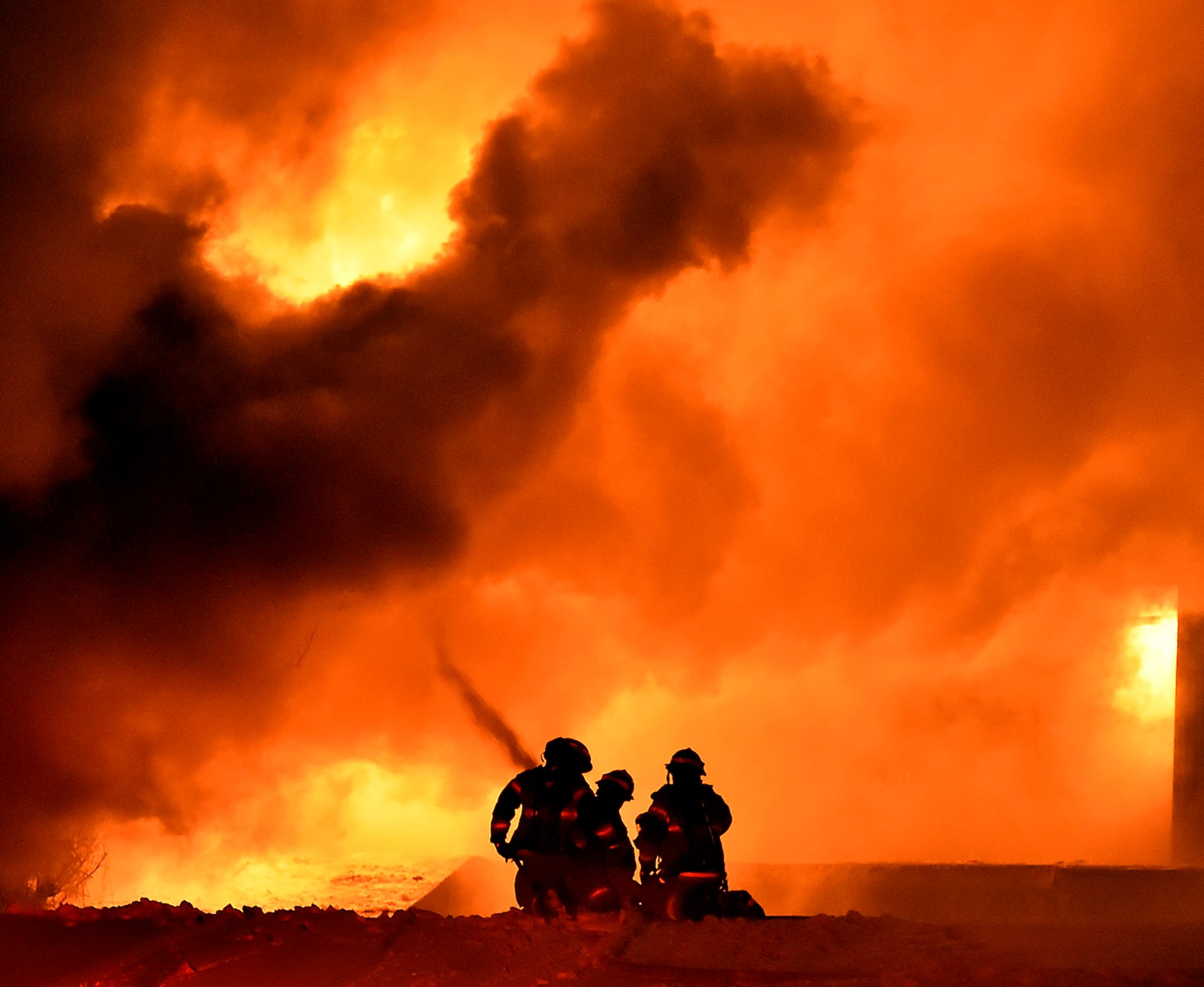 Members of the Springfield Fire Division battle a five alarm fire at Tri-State Pallet in downtown Springfield Tuesday evening. Bill Lackey/Staff