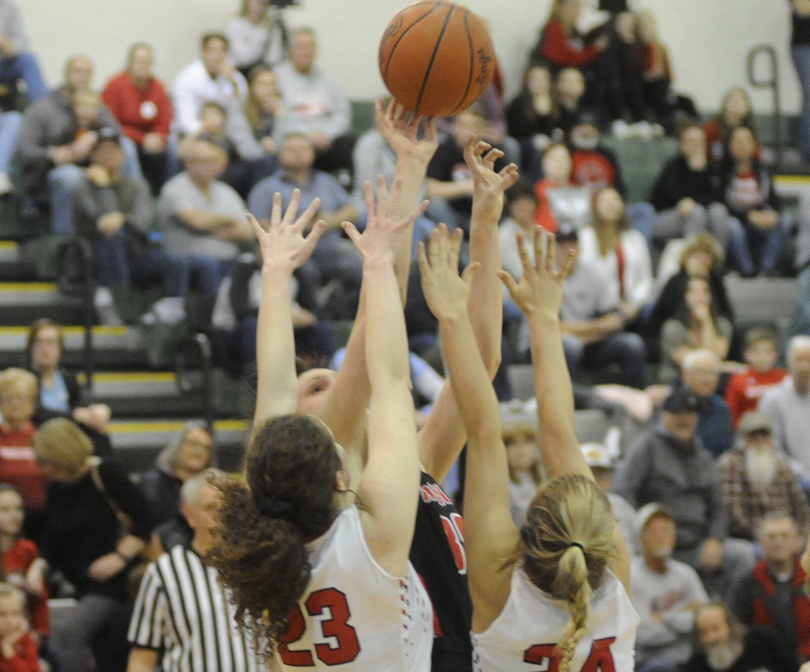 Franklin’s Layne Ferrell is tightly guarded by Tippecanoe’s Rachel Wildermuth (23) and Kendall Clodfelter (24) during Friday night’s Division II district basketball final at Mason Arena. Franklin won 49-39. MARC PENDLETON/STAFF