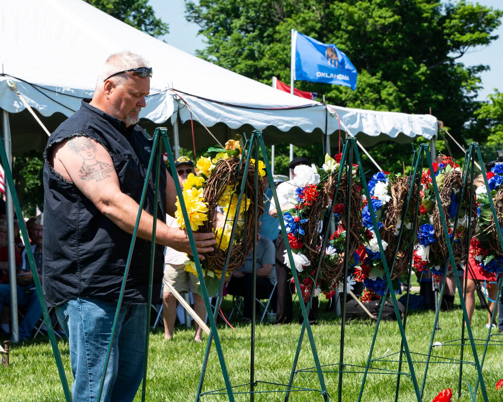 James P. White, Sr. lays a wreath in honor of his son, Army Pfc. James P. White, Jr., during a Memorial Day ceremony May 30 at Dayton National Cemetery in Dayton. Pfc. White was killed in action in Afghanistan in 2006 while serving with 1st Battalion, 32nd Infantry Regiment, 3rd Brigade Combat Team. U.S. Air Force photo/Jaima Fogg