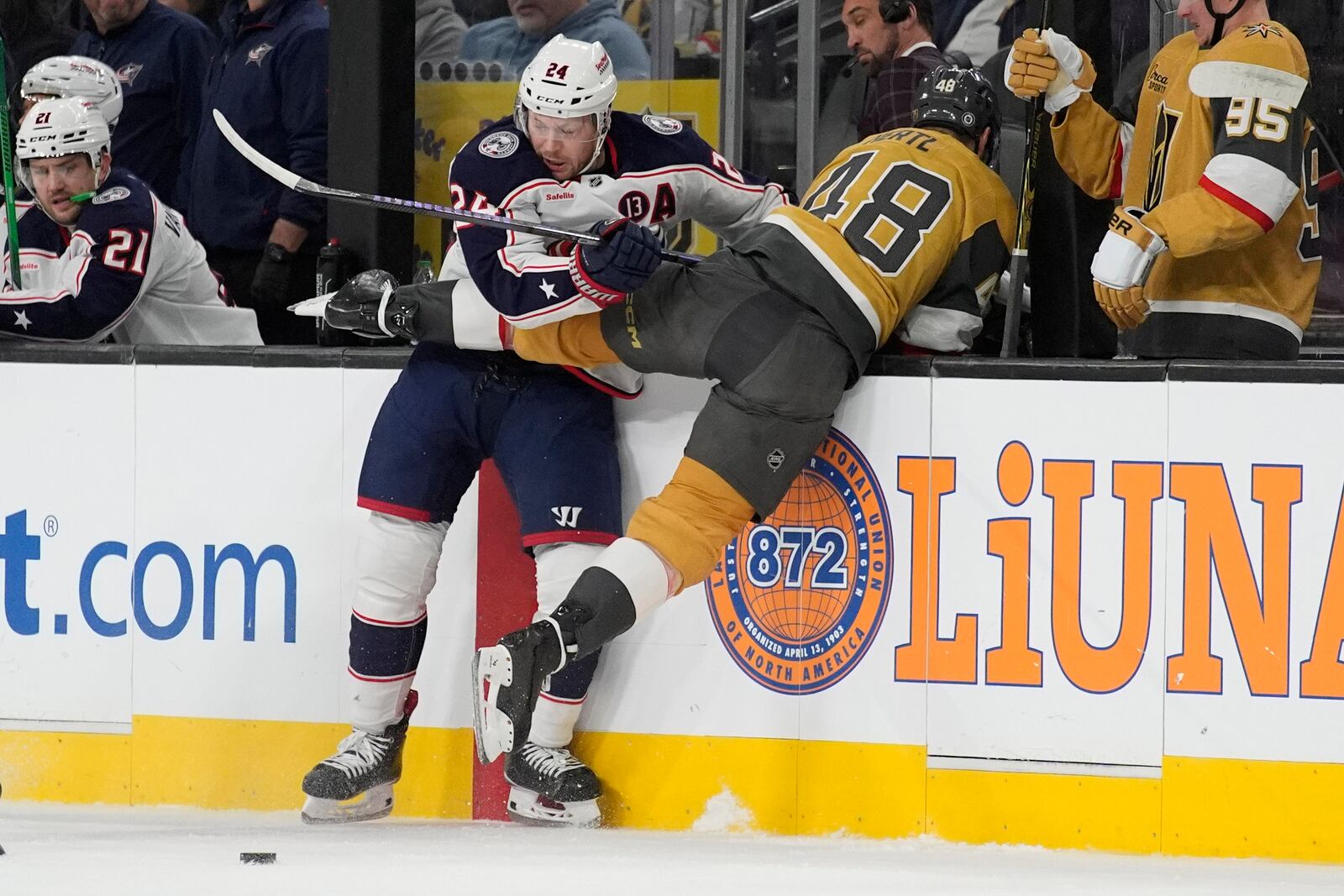 Columbus Blue Jackets right wing Mathieu Olivier (24) checks Vegas Golden Knights center Tomas Hertl (48) during the first period of an NHL hockey game Thursday, Jan. 30, 2025, in Las Vegas. (AP Photo/John Locher)