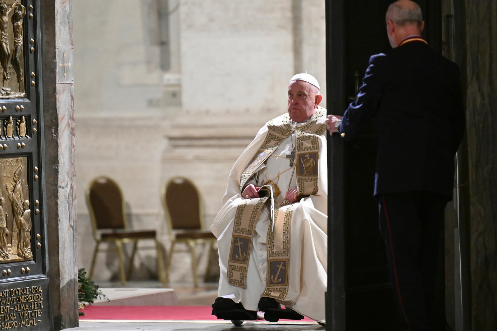 Pope Francis opens the Holy Door of St Peter's Basilica to mark the start of the Catholic Jubilee Year, at the Vatican, Dec. 24, 2024. (Alberto Pizzoli/Pool Photo via AP)