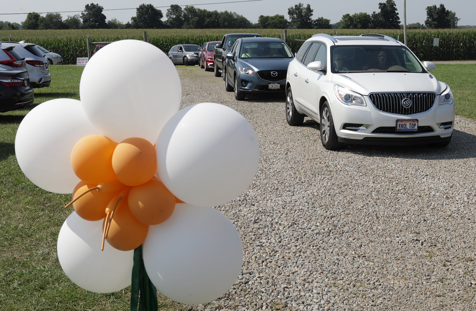 Golden Anniversary couples wait in their cars Tuesday at the Clark County Fair for the Golden Anniversary drive-thru for couples married for 50 years or more. BILL LACKEY/STAFF