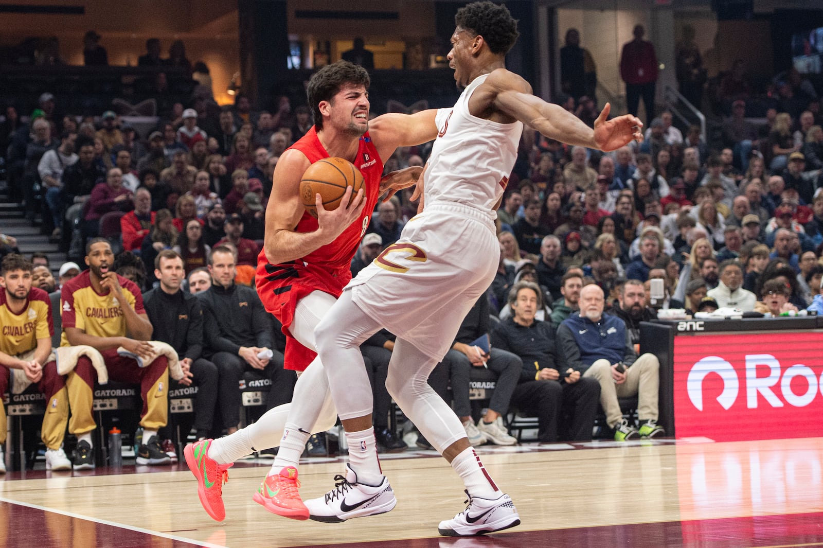 Portland Trail Blazers' Deni Avdija, left, is fouled by Cleveland Cavaliers' De'Andre Hunter, right, during the first half of an NBA basketball game in Cleveland, Sunday, March 2, 2025. (AP Photo/Phil Long)