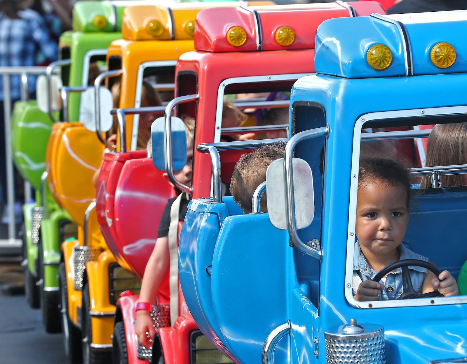 Neveah Byrd, 3, was very serious about her truck driving as she waited for a ride to begin at last year’s New Carlisle Heritage of Flight Festival. BILL LACKEY/STAFF