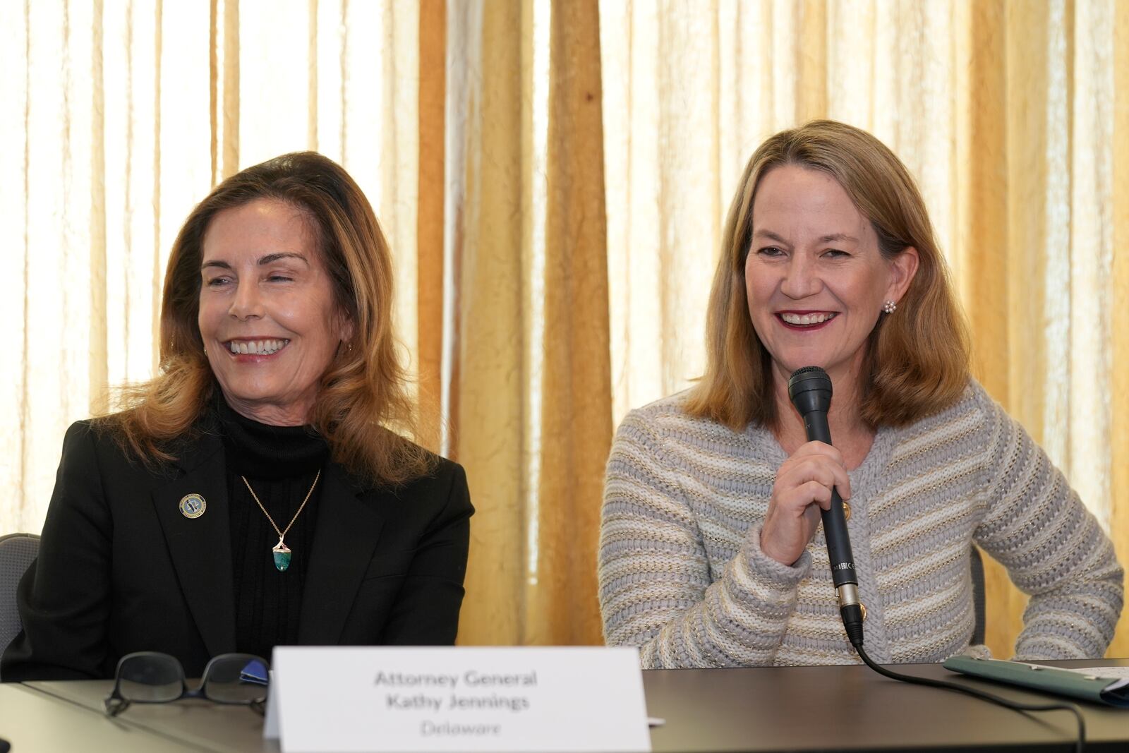 Attorney Generals, Kathy Jennings, Delaware, left, and Kris Mayes, Arizona comment on the numerous lawsuits states have filed against the Trump administration since the president's re-election during a news conference in Los Angeles, Tuesday, Feb. 11, 2025. (AP Photo/Damian Dovarganes)