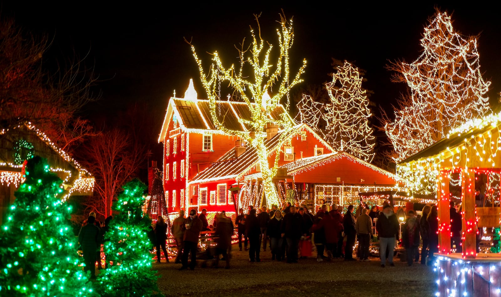 Visitors take in the Legendary Lights at the historic Clifton Mill, just outside Yellow Springs, Friday, Dec. 2, 2022. The mill, built in 1802 and still a working, has become a Miami Valley institution around the holidays. GREG LYNCH / STAFF