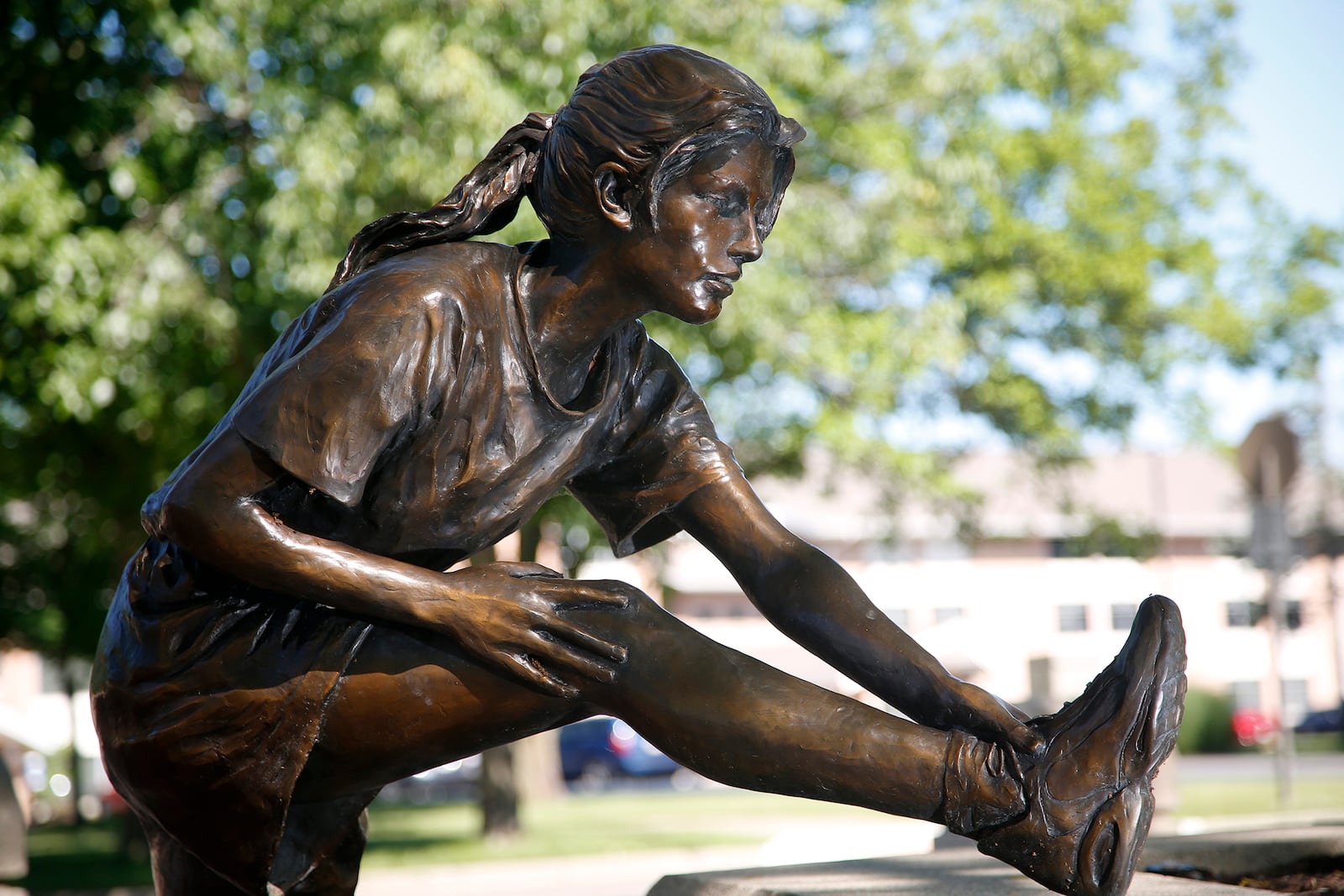 "The Runner," is made of bronze and created by Glenna Goodacre. It is located in Kettering's Lincoln Park Commons.  LISA POWELL / STAFF