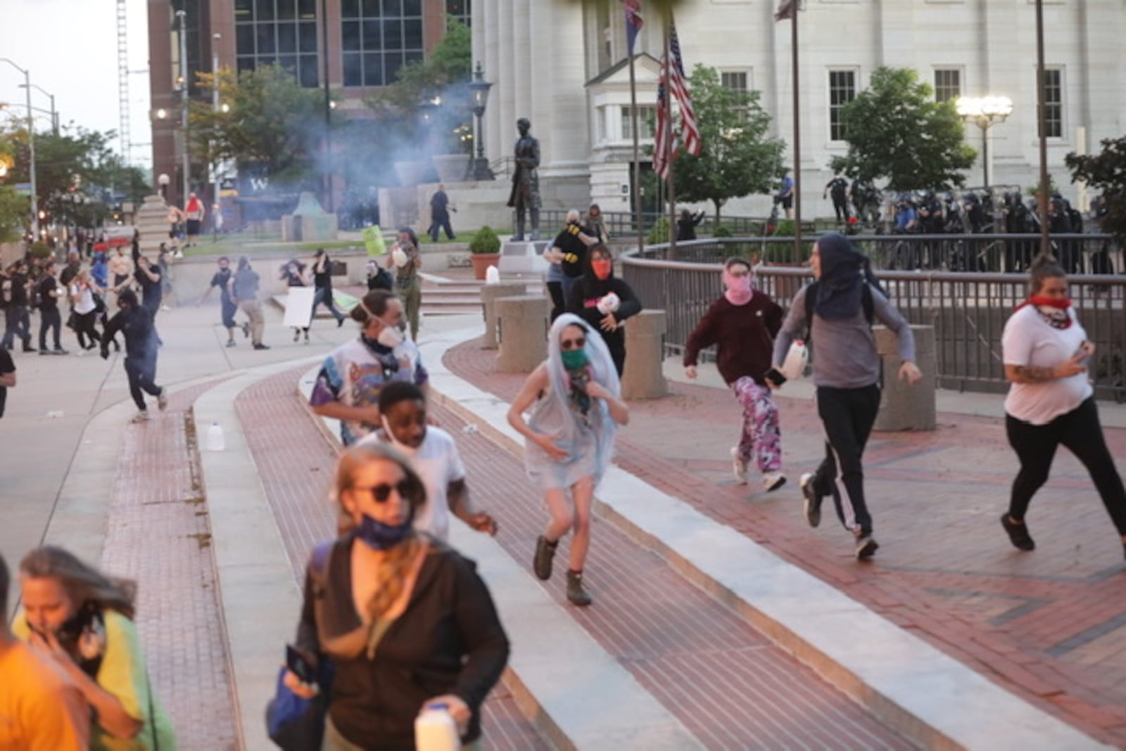 Police fired tear gas into a crowd at Courthouse Square in Dayton just after a curfew went into effect for the Oregon District and downtown areas at 9 p.m. / STAFF PHOTO BILL LACKEY