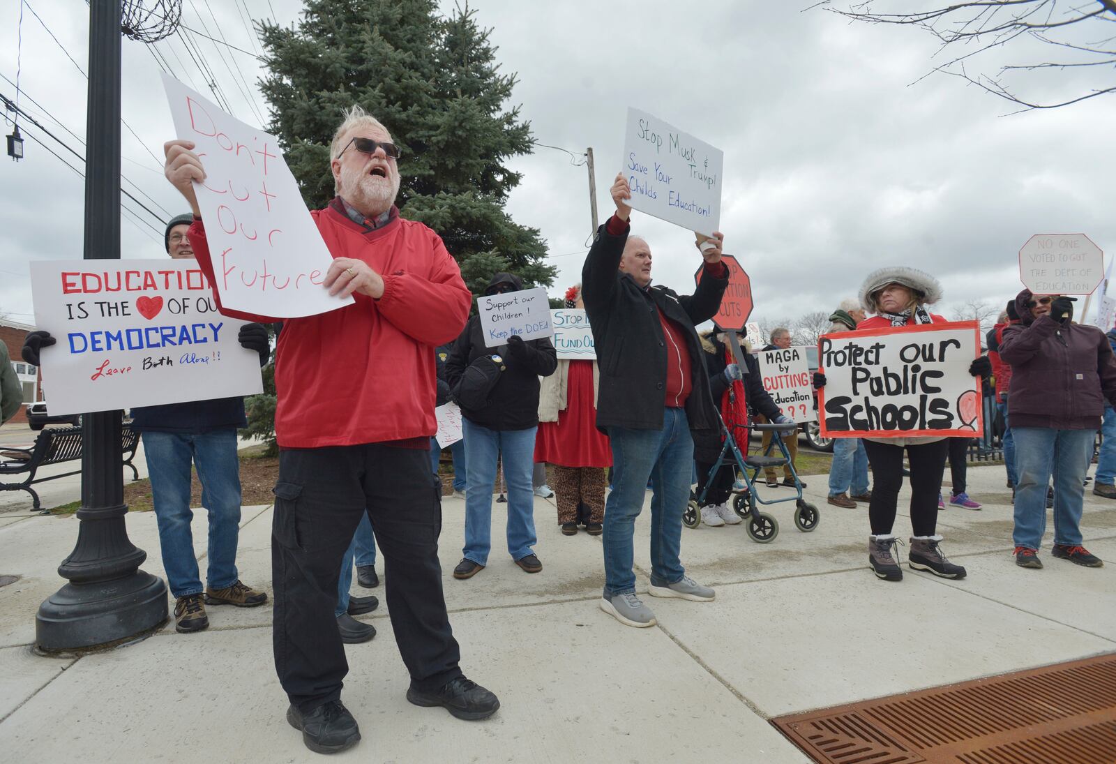 Dozens of people gather in downtown Niles, Mich., Thursday, March 20, 2025, to protest recent government cuts in the Department of Education. (Don Campbell/The Herald-Palladium via AP)