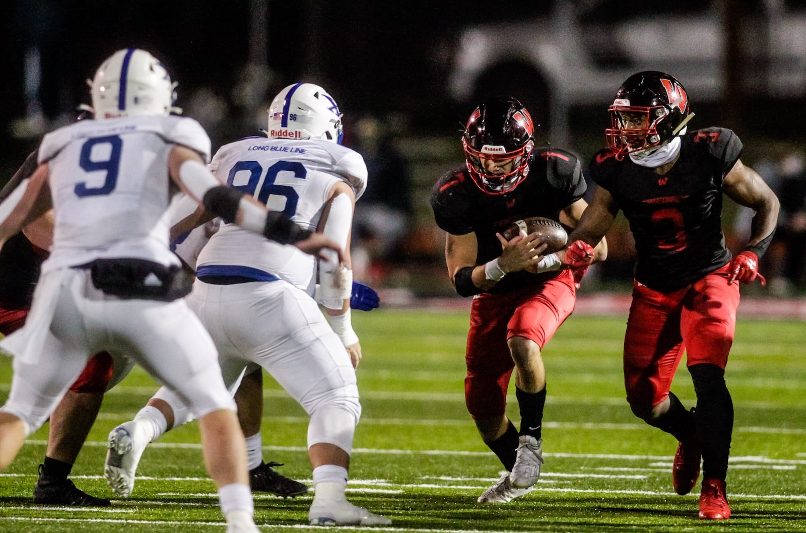 Lakota West quarterback Mitch Bolden carries the football with Joshua Brogden blocking for him during their playoff football game against St. Xavier Friday, October 30, 2020 at Lakota West High School in West Chester Township. The St. Xavier Bombers won 10-7 to advance to the state semifinal. NICK GRAHAM / STAFF