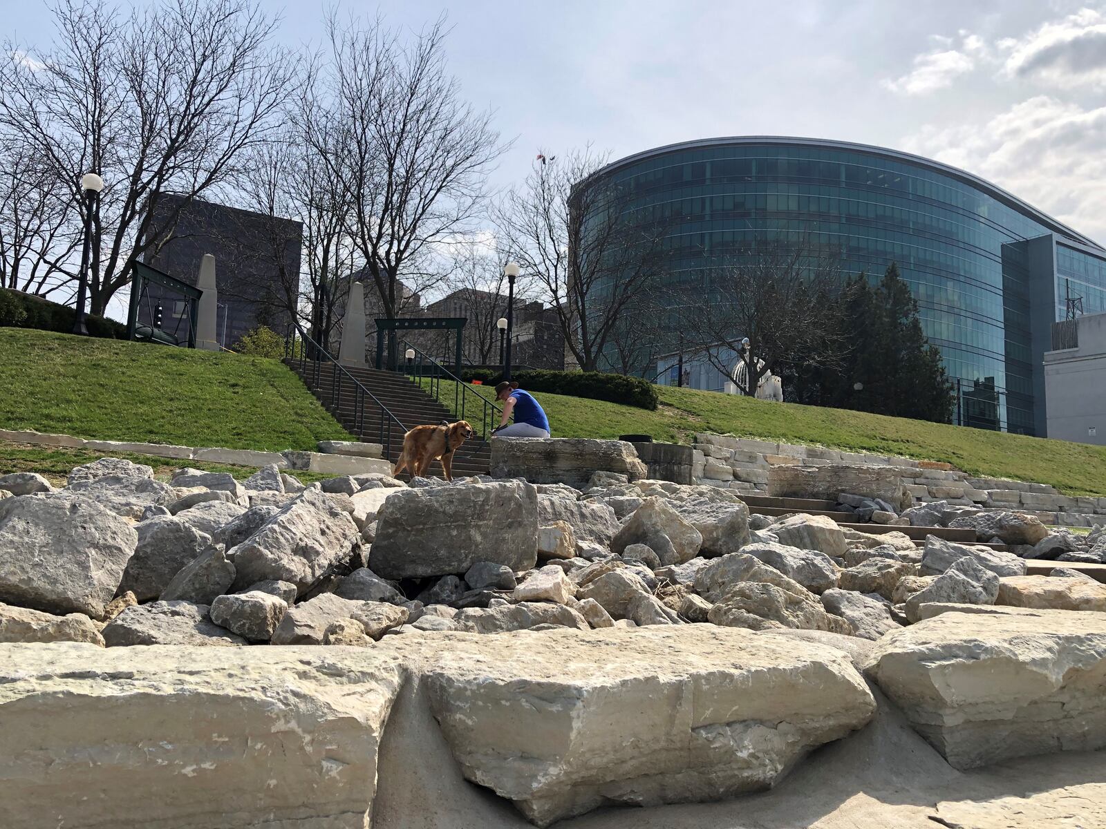 A man and his dog take a walk along the banks of the Great Miami River at RiverScape. CORNELIUS FROLIK / STAFF