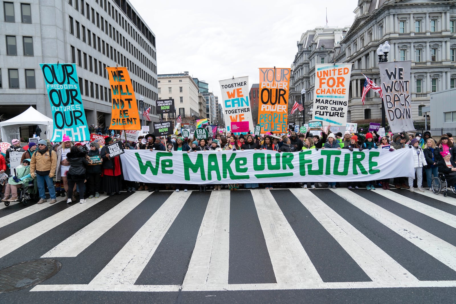 Demonstrators walk on the street as they participate in the People's March, Saturday, Jan. 18, 2025, in Washington. (AP Photo/Jose Luis Magana)