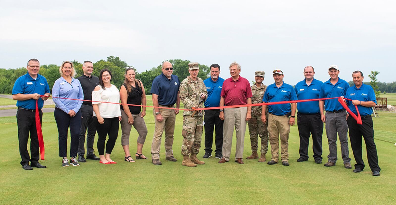 U.S. Air Force Col. Paul Burger, 88th Mission Support Group commander, along with other distinguished visitors, cut the ribbon of newly designed holes 7 and 8 of the Prairie Trace golf course, June 25, 2021, at Wright-Patterson Air Force Base, Ohio. The cutting marks the completion of the first phase of a multi-mission dollar program which required the previous holes to be moved to make room for the expansion of the National Air and Space Intelligence Center. (U.S. Air Force photo by Wesley Farnsworth)