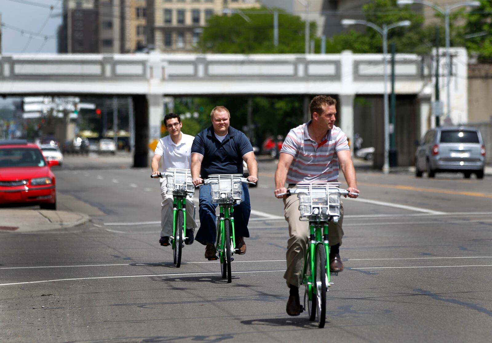 Eric Wright, Chris Lialios and Stetson Blake (front to rear) checked out bicycles from the Link Dayton Bike Share in downtown Dayton to ride from their office to Brown Street to have lunch. LISA POWELL / STAFF 2015 FILE PHOTO