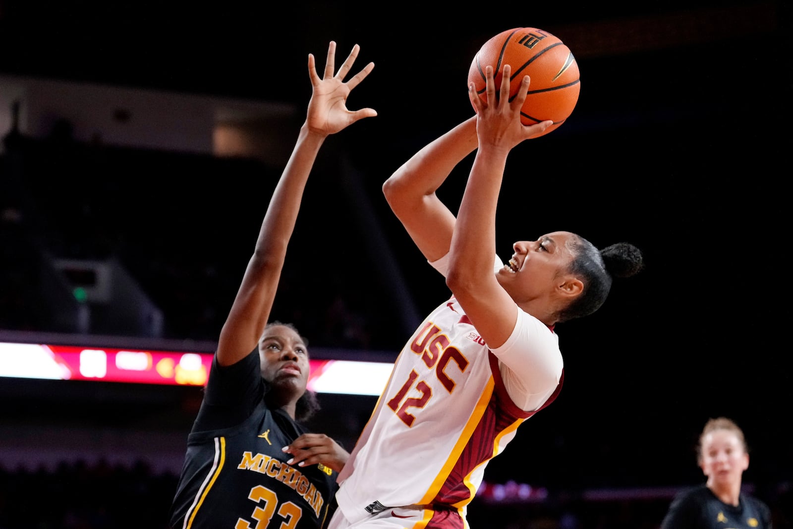 Southern California guard JuJu Watkins, right, shoots as Michigan guard Te'Yala Delfosse defends during the second half of an NCAA college basketball game, Sunday, Dec. 29, 2024, in Los Angeles. (AP Photo/Mark J. Terrill)