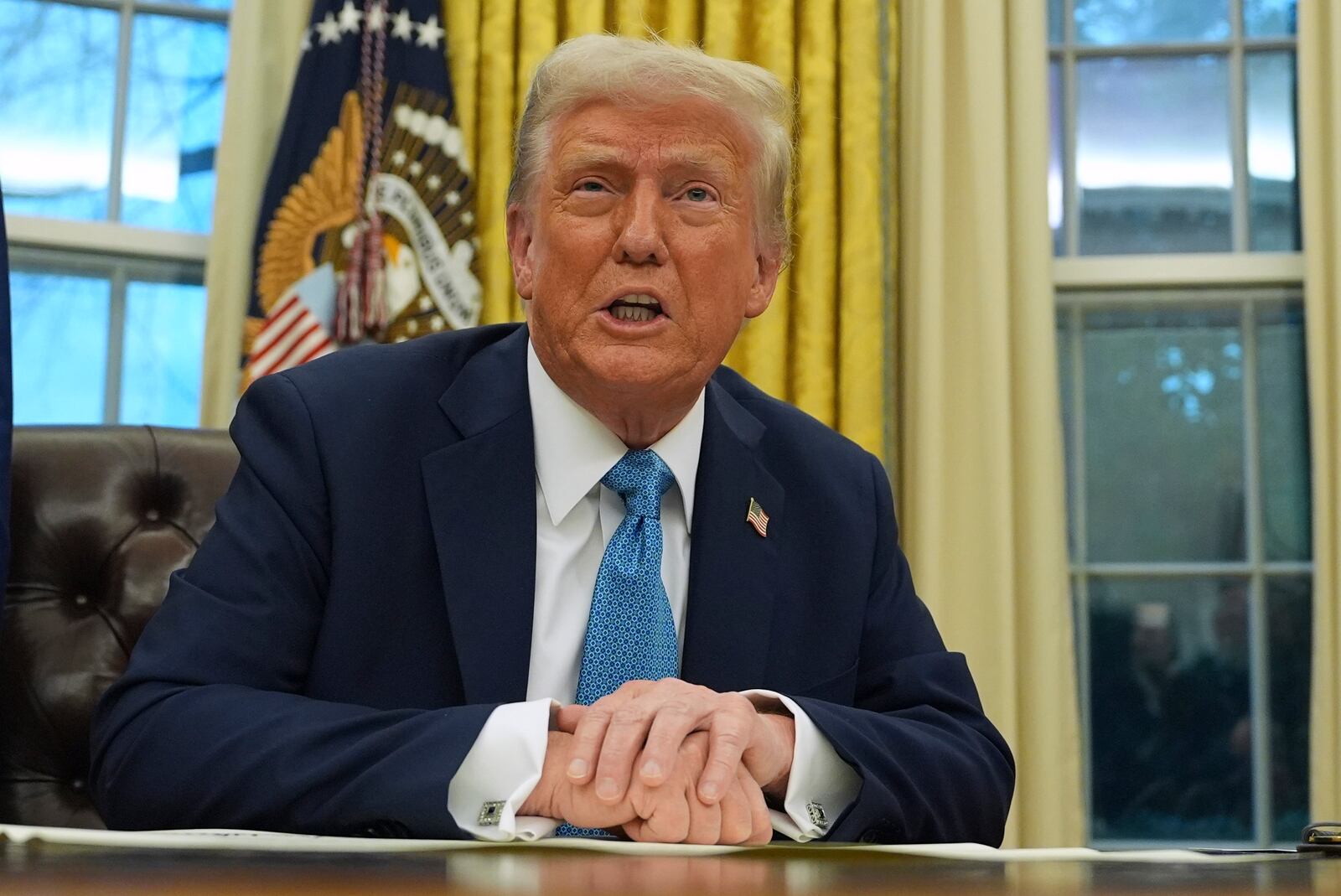 President Donald Trump speaks to reporters as he signs executive orders in the Oval Office of the White House, Friday, Jan. 31, 2025, in Washington. (AP Photo/Evan Vucci)