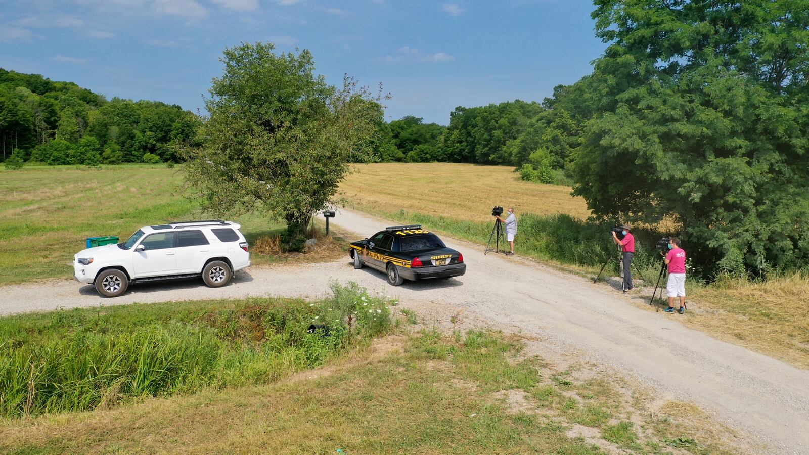 Law enforcement and members of the media are shown near Ohio House Speaker Larry Householder's farm in Perry County, where federal officials responded on Tuesday morning. DENNIS FISHER/CONTRIBUTING PHOTOGRAPHER