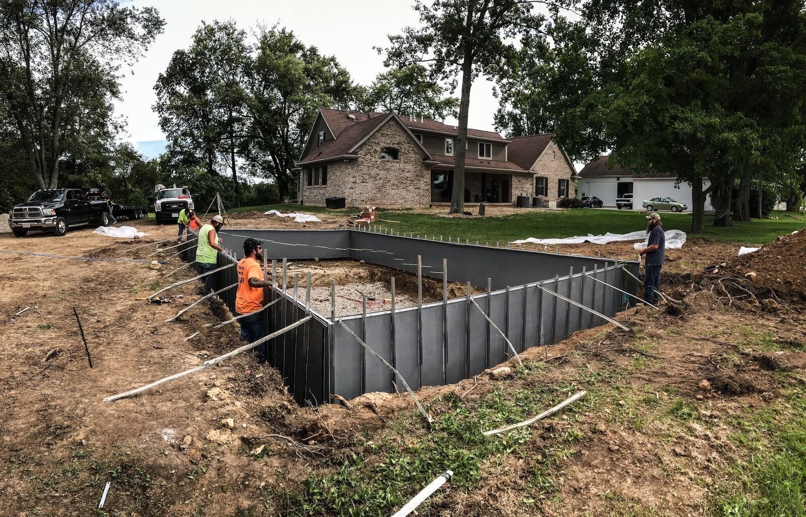 Buckeye Pool Company employees work on a pool in Tipp City on Monday, Aug. 17, 2020. The COVID-19 pandemic has helped Buckeye, which installs 45 to 50 pools a year. The company is already booked solid for all of 2021. JIM NOELKER/STAFF