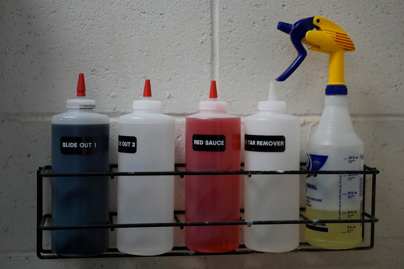 Solutions to clean a variety of stains and pine tar are stored above the San Francisco Giants laundry room sink during baseball spring training at the team's facility, Monday, Feb. 17, 2025, in Scottsdale, Ariz. (AP Photo/Carolyn Kaster)