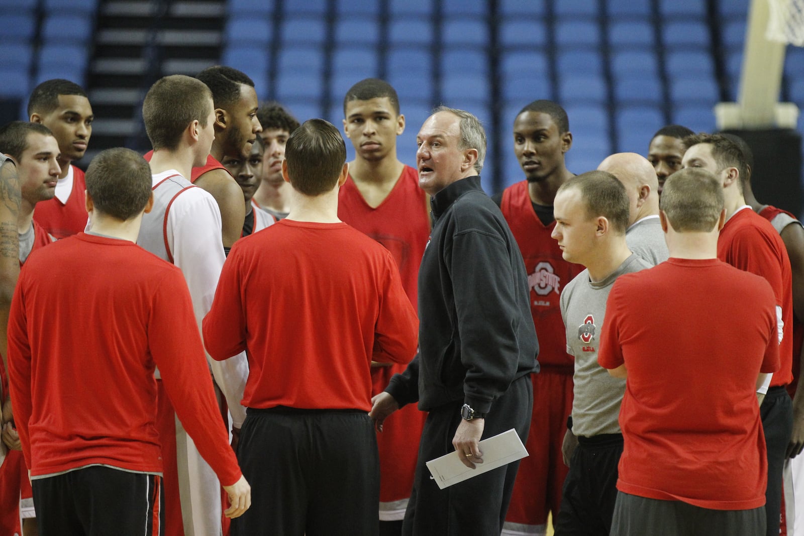 Ohio State’s coach Thad Matta, center, gathers the team in a huddle before practice for the NCAA tournament on Wednesday, March 19, 2014, at First Niagara Center in Buffalo, N.Y. David Jablonski/Staff