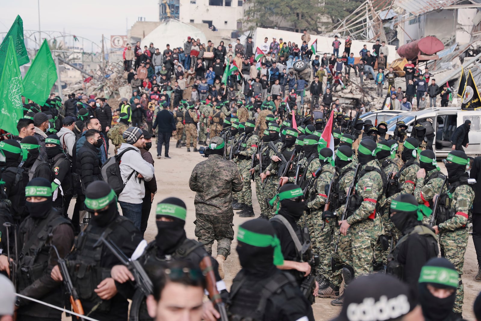 Hamas fighters are deployed in central Gaza City ahead of the planned release of four Israeli female hostages set to be handed over to the Red Cross in Gaza City on Saturday, Jan. 25, 2025. (AP Photo/Abed Hajjar)