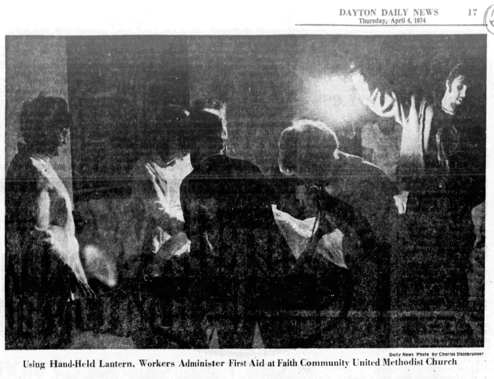 Using hand-held lantern, workers administer first aid at Faith Community United Methodist Church after the Xenia tornado of 1974. DAYTON DAILY NEWS ARCHIVES.