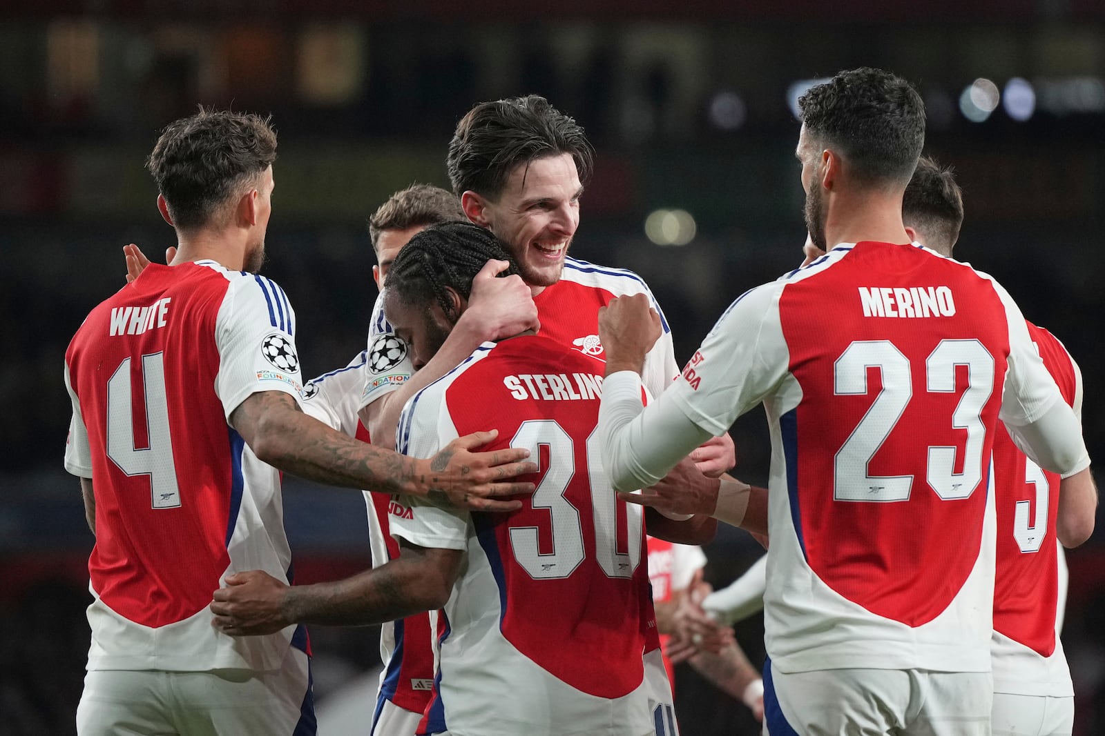 Arsenal's Declan Rice, centre, celebrates with teammates after scoring his side's second goal during the Champions League round of 16 second leg soccer match between Arsenal FC and PSV Eindhoven at the Arsenal stadium in London, England, Wednesday, March 12, 2025. (AP Photo/Alastair Grant)