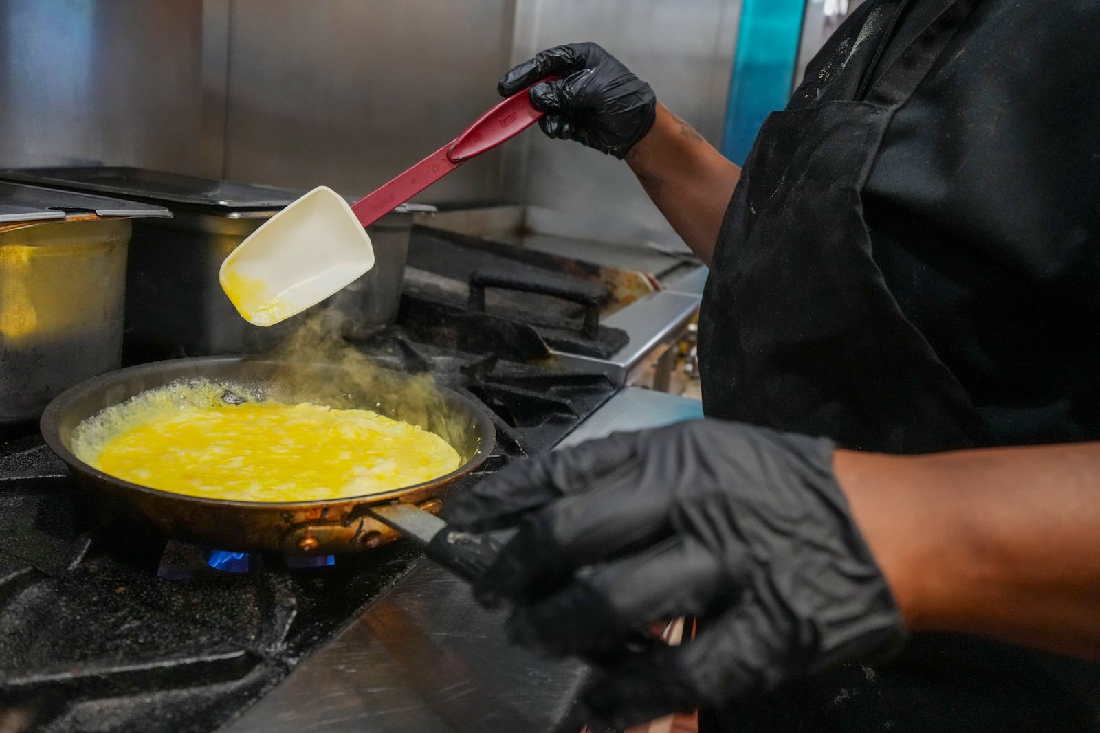 Johkiya Pierre prepares a fresh omelette at The Breakfast Brothers restaurant, Wednesday, Feb. 12, 2025, in Arlington, Texas. (AP Photo/Julio Cortez)