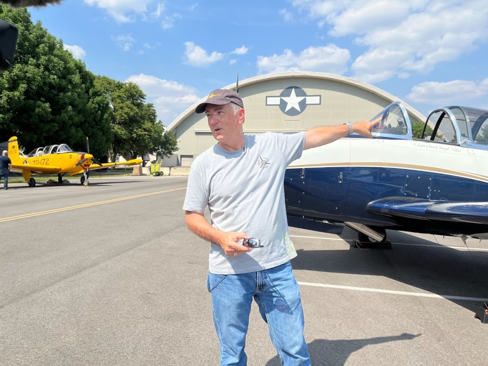 Tim Gause, a former Air Force pilot, talks about what he loves about his T-34 airplane Friday at the National Museum of the U.S. Air Force. THOMAS GNAU/STAFF