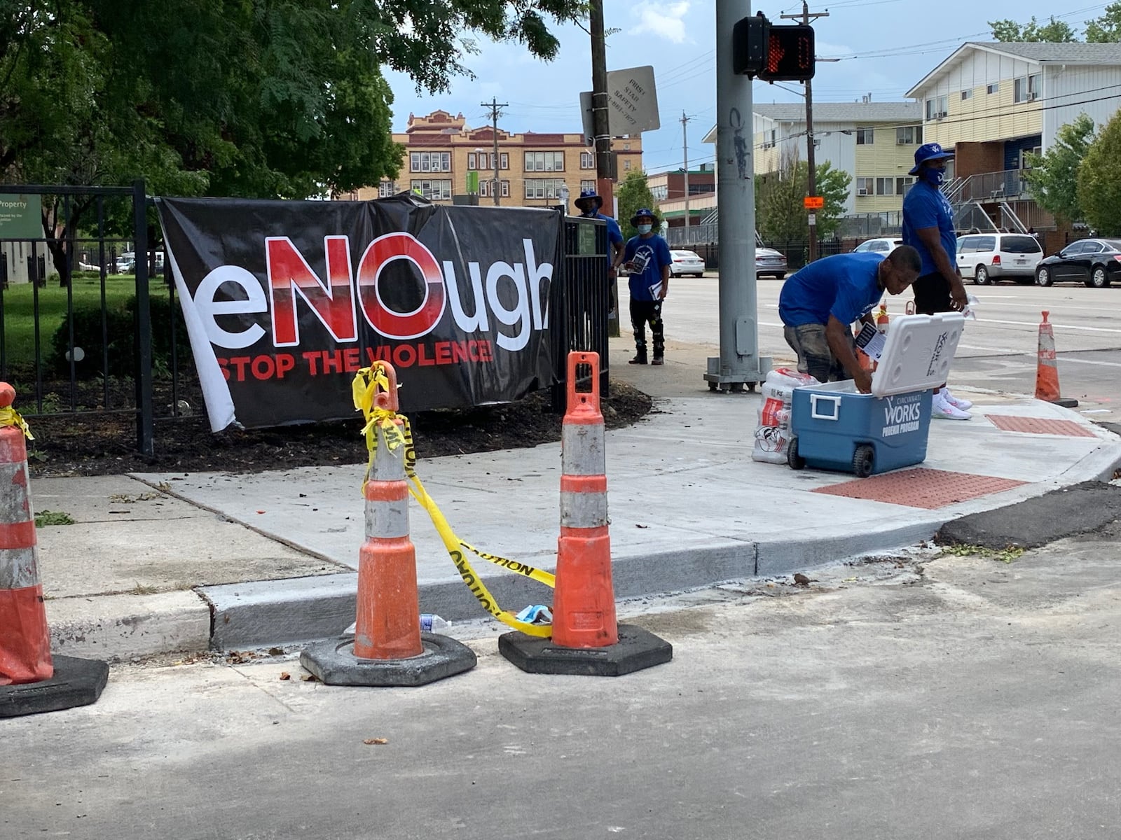 Representatives of the non-profit Cincinnati Works distributes job training literature at Liberty and Linn streets on Sunday afternoon. The area is among four locations in Cincinnati where police say unrelated shootings occurred overnight, killing four and injuring 14. /Ed Richter