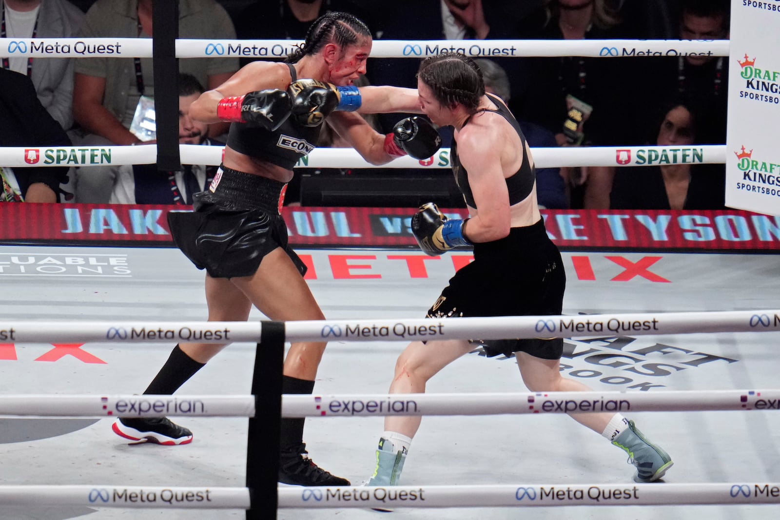 Katie Taylor, right, lands a right to Amanda Serrano during their undisputed super lightweight title bout, Friday, Nov. 15, 2024, in Arlington, Texas. (AP Photo/Julio Cortez)