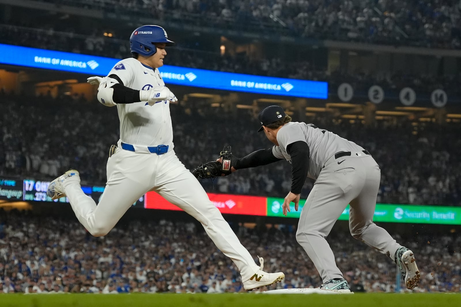 Los Angeles Dodgers' Shohei Ohtani is forced out a first by New York Yankees first baseman Anthony Rizzo during the sixth inning in Game 1 of the baseball World Series, Friday, Oct. 25, 2024, in Los Angeles. (AP Photo/Ashley Landis)