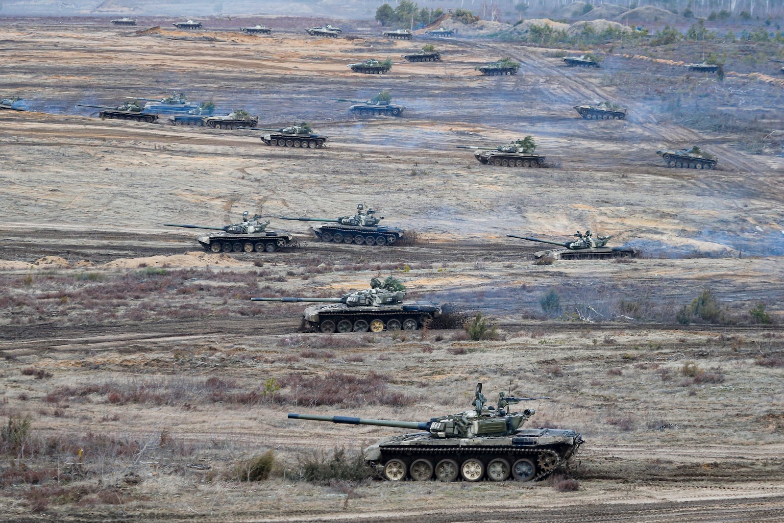 FILE - Tanks move during the Union Courage-2022 Russia-Belarus military drills at the Obuz-Lesnovsky training ground in Belarus, Feb. 19, 2022. (AP Photo/Alexander Zemlianichenko Jr., File)