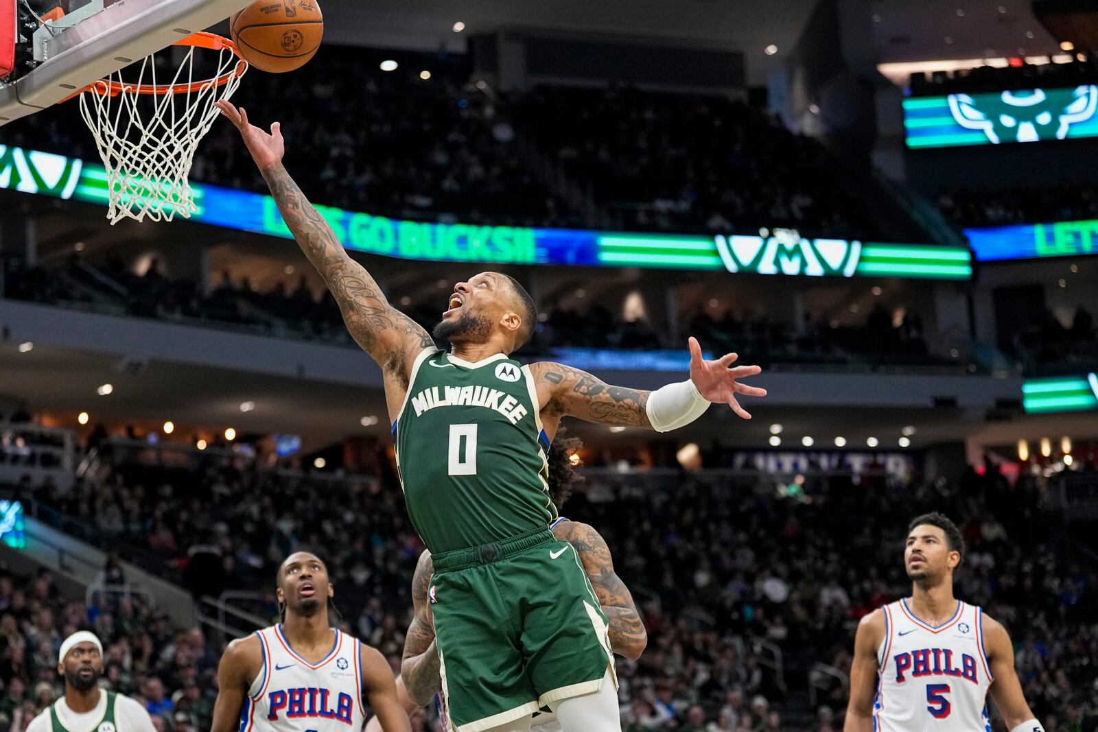 Milwaukee Bucks' Damian Lillard (0) shoots against the Philadelphia 76ers during the second half of an NBA basketball game Sunday, Feb. 9, 2025, in Milwaukee. (AP Photo/Andy Manis)