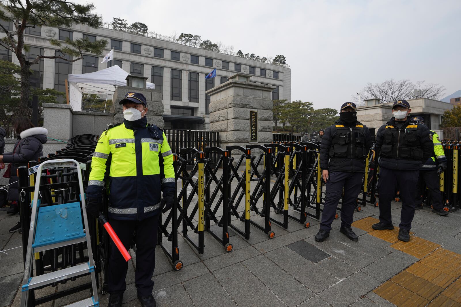 South Korean police officers stand in front of the Constitutional Court in Seoul, South Korea, Tuesday, Jan. 14, 2025. (AP Photo/Lee Jin-man)