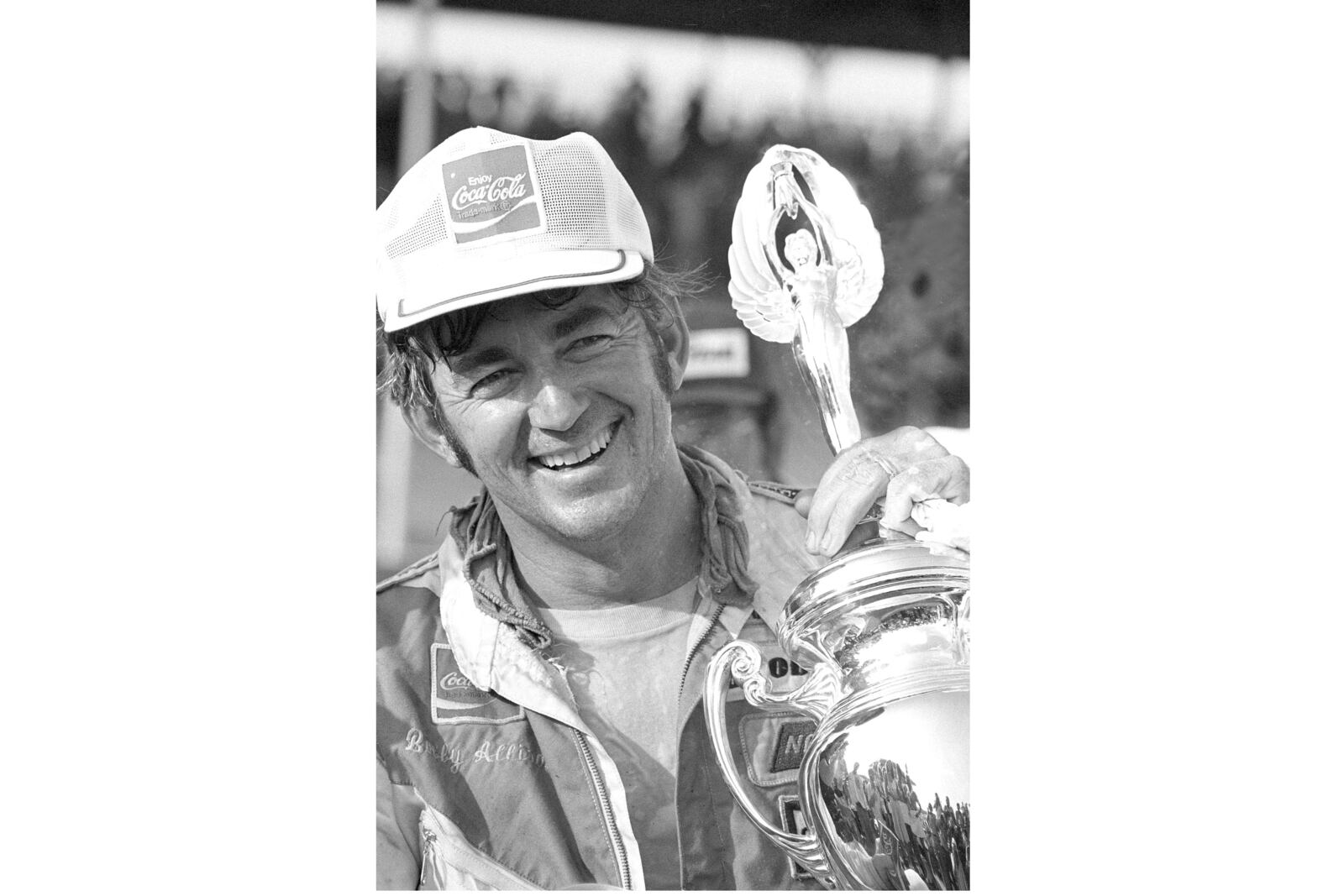 FILE - Bobby Allison holds his trophy in Victory Lane after winning the Southern 500 stock car race at Darlington, S.C., Sept. 1, 1975. (AP Photo/File)