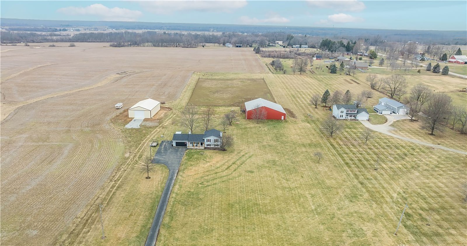 The five acre property includes a barn with horse stalls and a tack room and a fenced pasture.