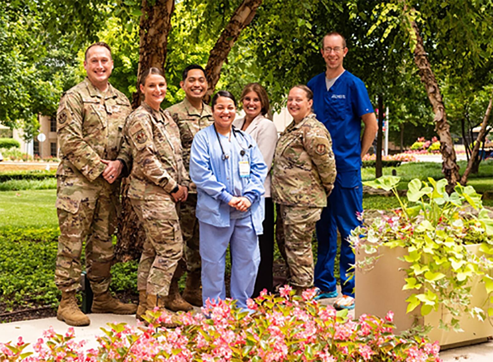 Wright-Patterson Medical Center leaders and colleagues stand with Tech. Sgt. Giselle Rodriguez (center) outside Miami Valley Hospital in Dayton on Aug. 11 to show their appreciation for her heroics after she stopped to help a young woman in labor the previous week. Also pictured (from left): Senior Master Sgt. Sean Patterson, 88th Healthcare Operations Squadron superintendent; Master Sgt. Maranda Oliver, section chief of medical specialties; Master Sgt. Maynard Galvez, Medical Specialties Flight chief; Tami Ashbridge, 88th Medical Group deputy director; Staff Sgt. Sara Shotts, respiratory care practitioner and 88 MDG’s Phase II/III course supervisor; and Dr. Andrew Berglund, chief of pulmonary medicine. U.S. AIR FORCE PHOTO/PAMELA PICCOLI