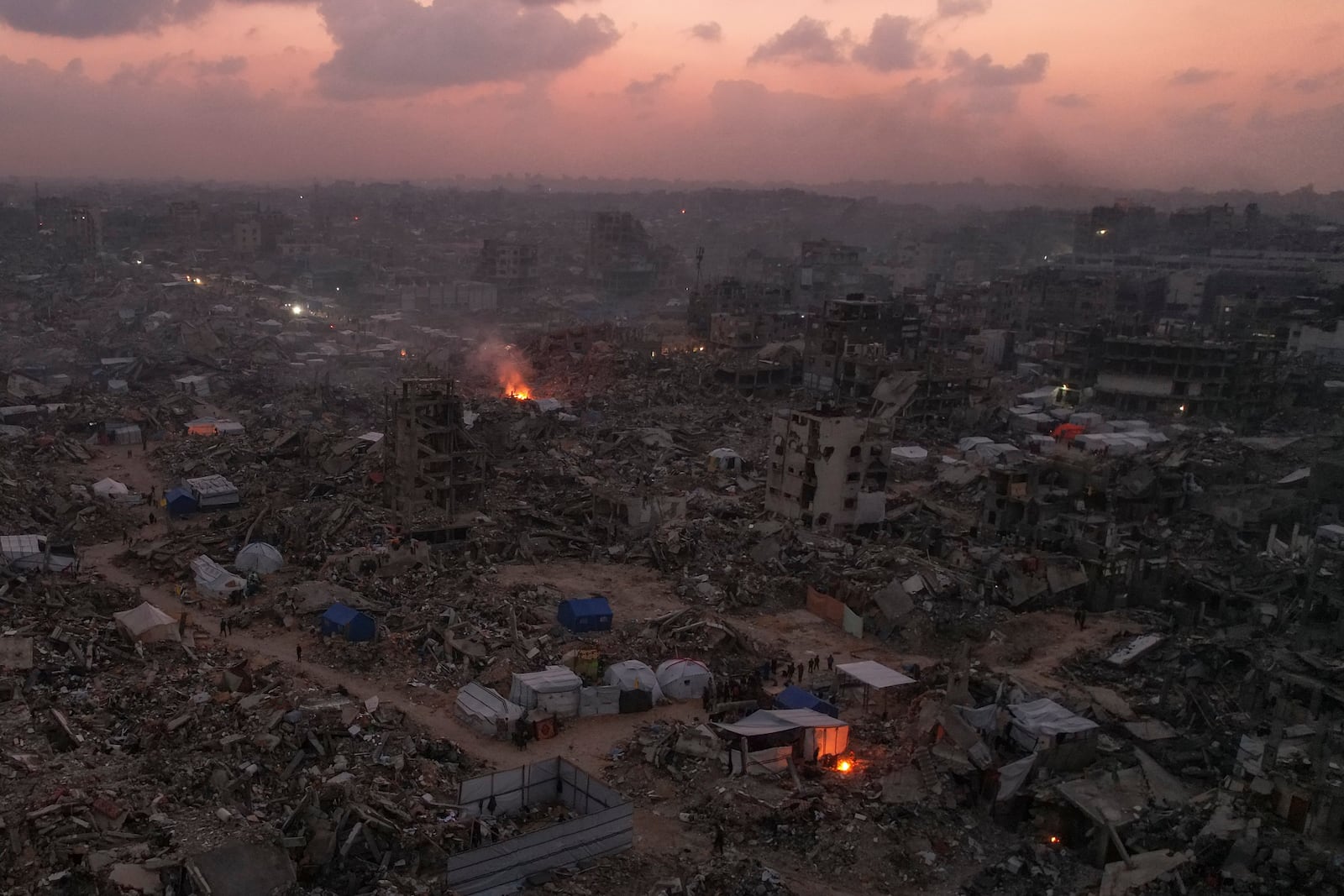 An aerial photograph taken by a drone shows tents between the destruction caused by the Israeli air and ground offensive in Jabaliya, Gaza Strip, on Sunday, Feb. 16, 2025. (AP Photo/Mohammad Abu Samra)