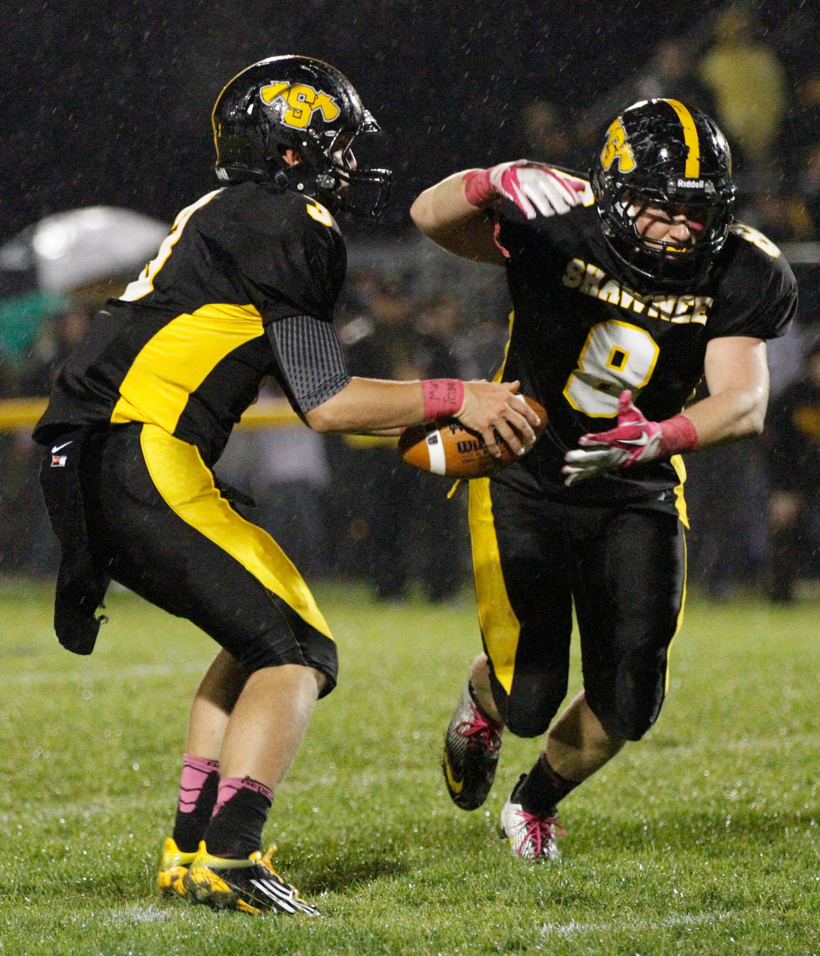 Shawnee quarterback Tyler Bostick (3) hands off to Alex McCrory (8) against Tecumseh on Oct. 5, 2012. SNS FILE PHOTO