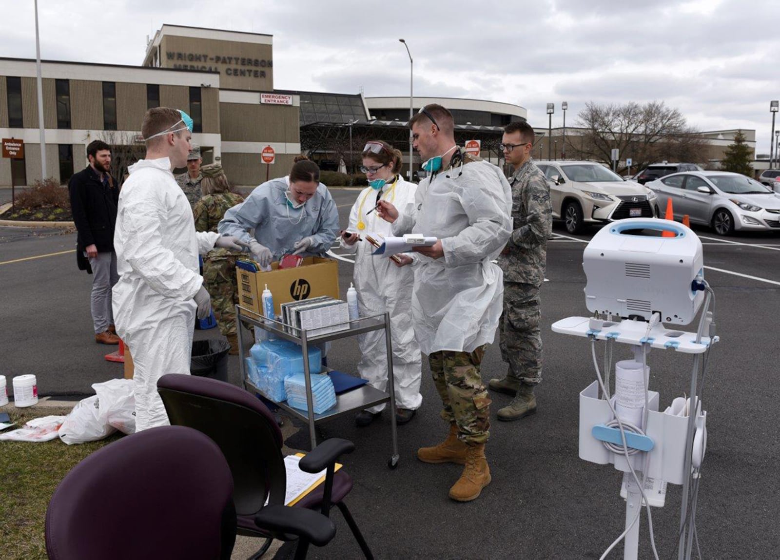 Air Force personnel prepare to screen patients in front of the Wright-Patterson Medical Center March 16. The 88th Medical Group staff began screening patients before they entered the medical center as part of the COVID-19 protocol instituted at the facility. U.S. AIR FORCE PHOTO/TY GREENLEES