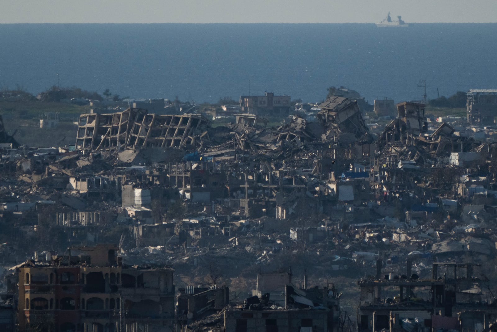 Buildings destroyed during the Israeli air and ground offensive are seen in the Gaza Strip from southern Israel, Sunday, March 2, 2025. (AP Photo/Leo Correa)