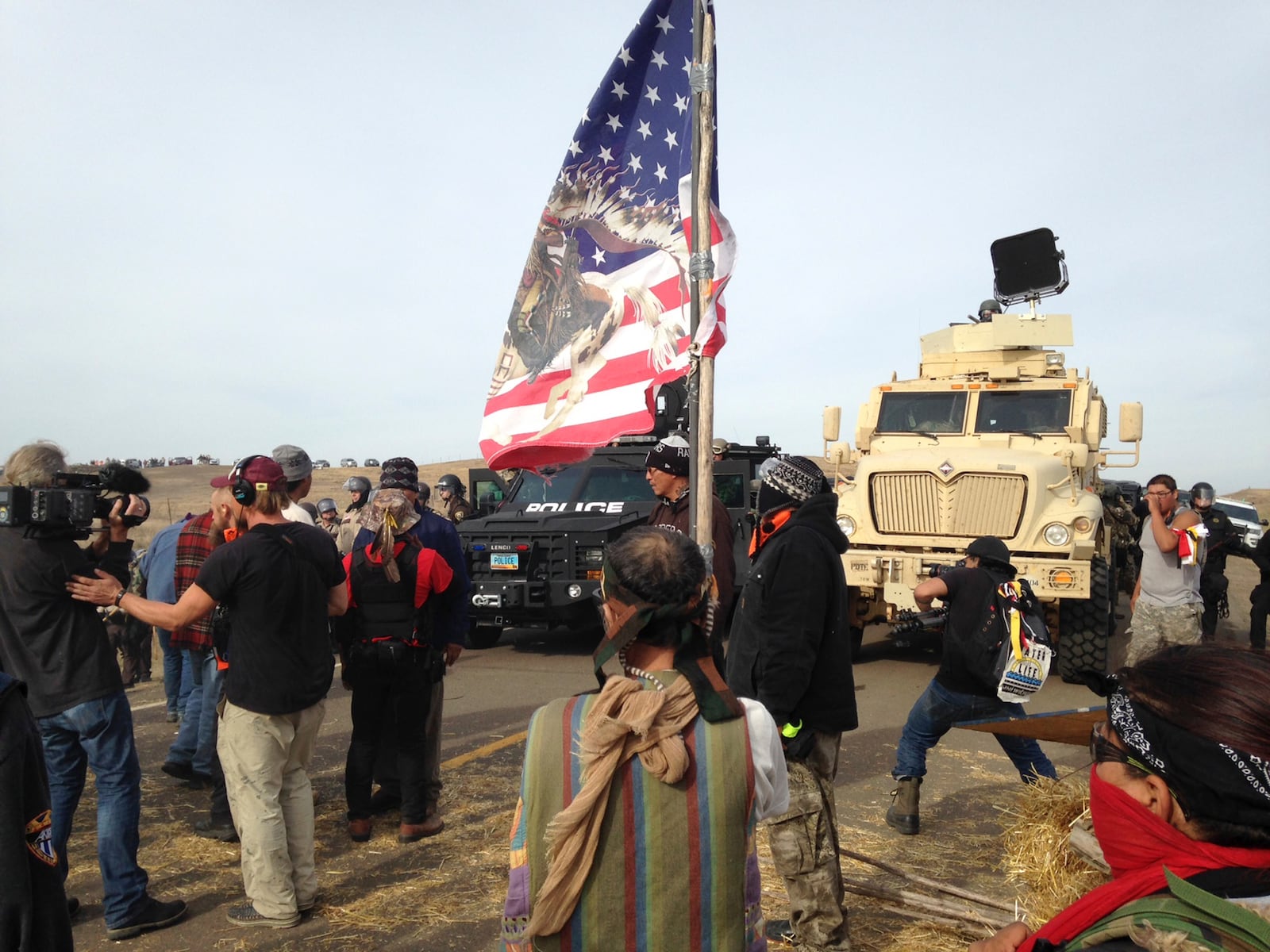 FILE - Dakota Access pipeline protesters defy law enforcement officers who are trying to force them from a camp on private land in the path of pipeline construction, Oct. 27, 2016, near Cannon Ball, N.D. (AP Photo/James MacPherson, File)