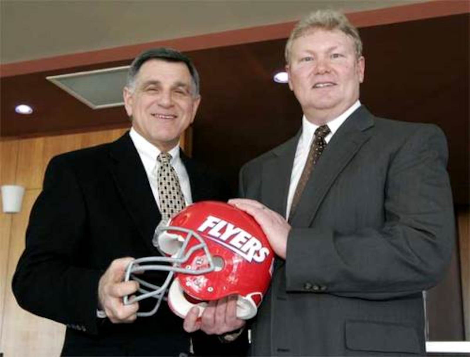 Rick Chamberlin (right) when he was introduced as the new head football coach of the University of Dayton Flyers. Chamberlin succeeds Mike Kelly (left). DDN file photo