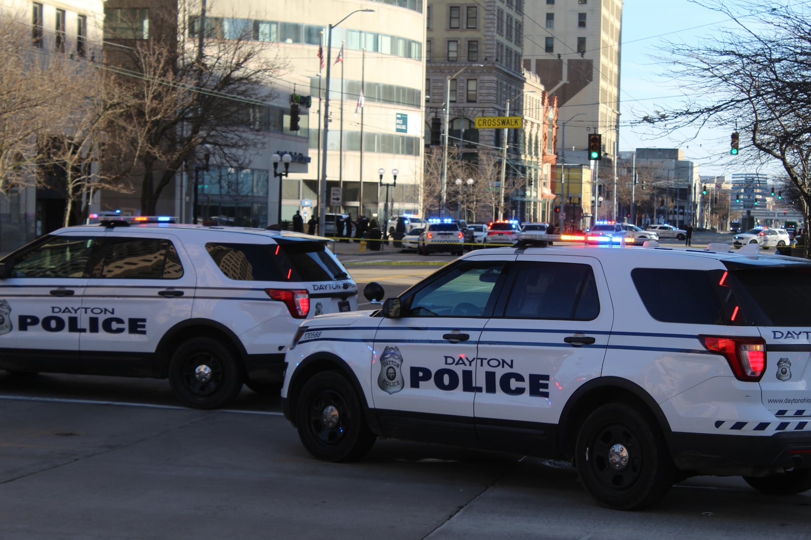 Dayton Police vehicles surround the scene of a reported standoff on late Sunday afternoon, March 3, on Main Street in downtown Dayton. CORY FROLIK/STAFF