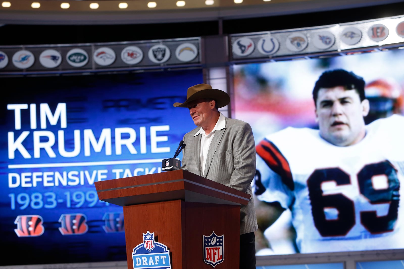 FILE - Former Cincinnati Bengals tackle Tim Krumrie announces a draft pick during the second round of the NFL Draft, Friday, April 26, 2013 at Radio City Music Hall in New York., Friday, April 26, 2013 at Radio City Music Hall in New York. The Cincinnati Bengals are adding running back Corey Dillon and nose tackle Tim Krumrie to the team's Ring of Honor this fall. (AP Photo/Jason DeCrow, File)