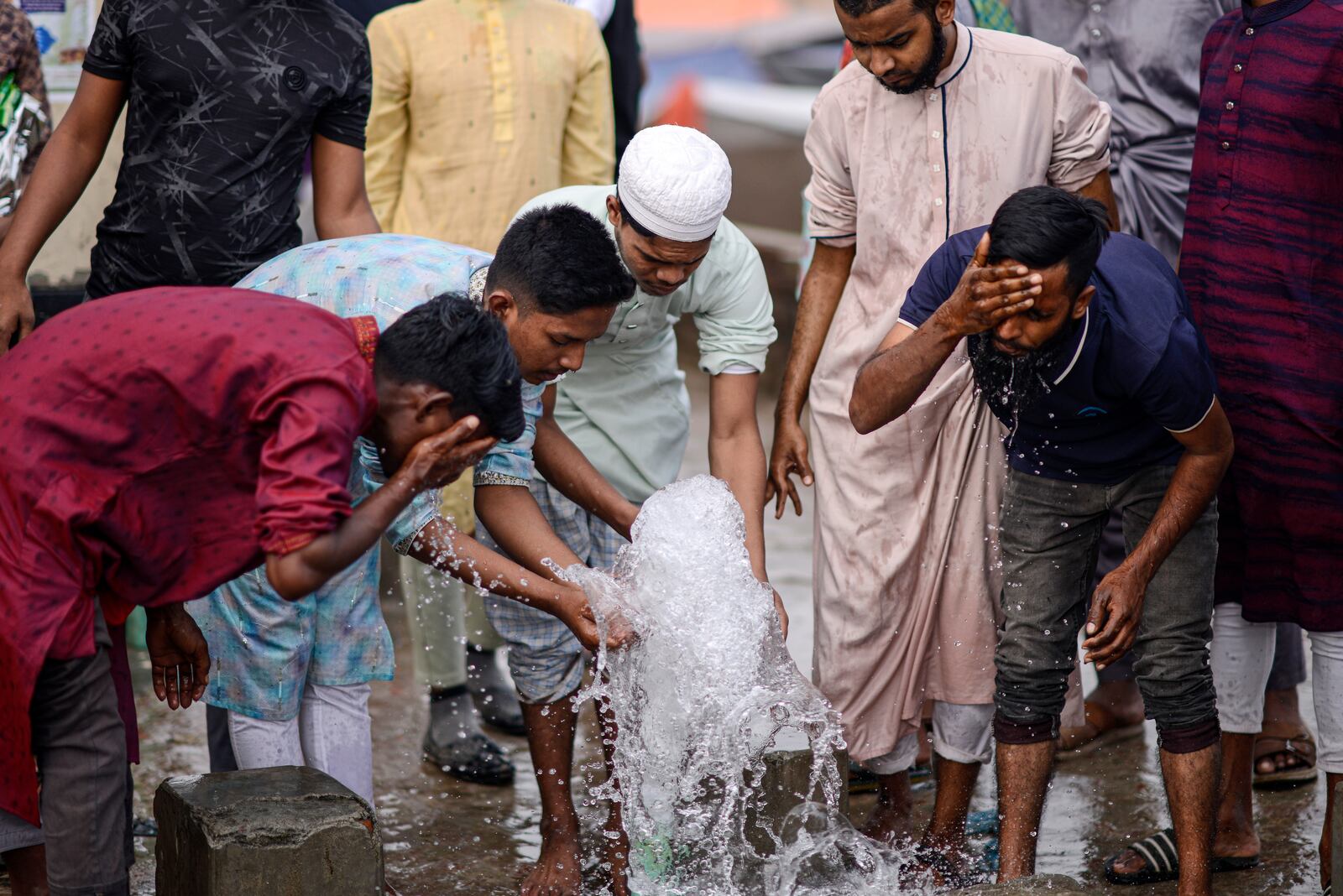 Muslim devotees perform ablutions before prayers during the first phase of the three-day Biswa Ijtema, or the World Congregation of Muslims, at the banks of the Turag river in Tongi, near Dhaka, Bangladesh, Friday, Jan. 31, 2025. (AP Photo/Mahmud Hossain Opu)